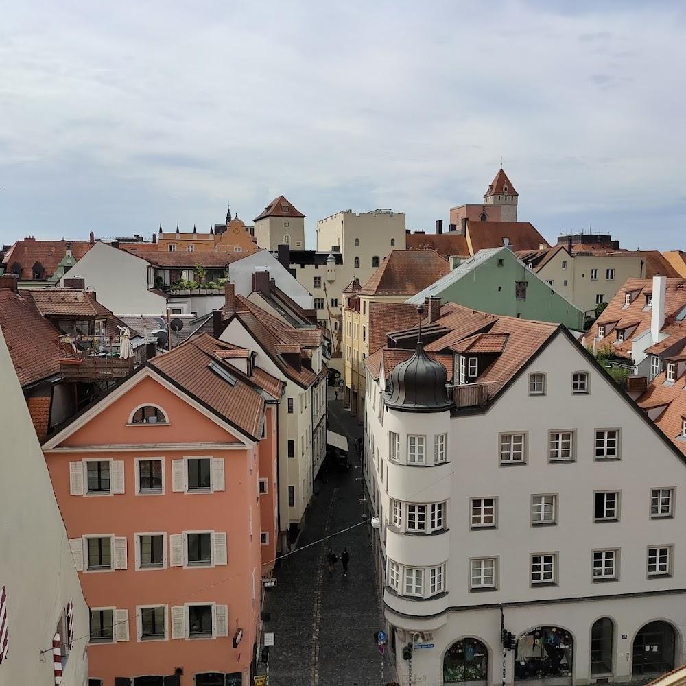 A street scene in a European town, with a view of the roofs of buildings.